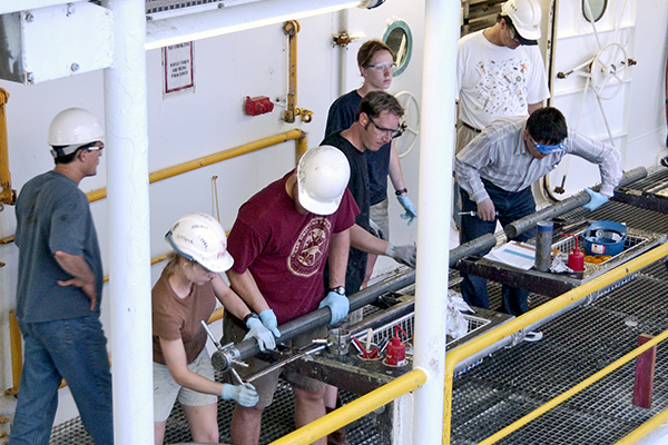 A sediment core being processed on the deck of the JOIDES Resolution. (Image courtesy of IODP.)
