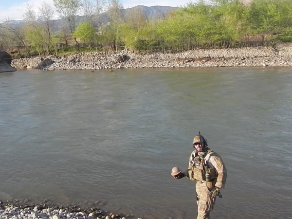 Lance Belobrajdic deploying a River Drifter Hydrology Sensor in Afghanistan in 2013. (Photo courtesy of the U.S. Air Force.)