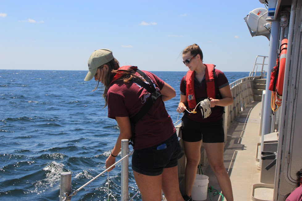 Victoria Scriven and a fellow oceanography student doing field work on a cruise. (Photo by Chris Mouchyn, Texas A&M Geosciences)