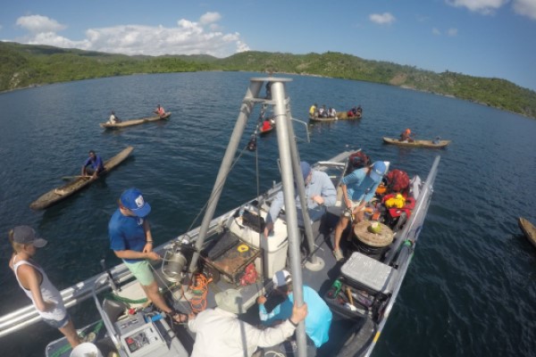 Researchers on the R/V Arenaria garner interest while collecting sediment cores in the Baie des Baradères in Haiti. (Photo by Nicole D'Entremont.)