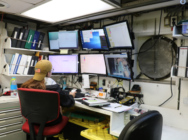Charlotte Miller, working at the CTD console on the R/V Point Sur in Summer 2019 (Photo courtesy of Charlotte Miller.)