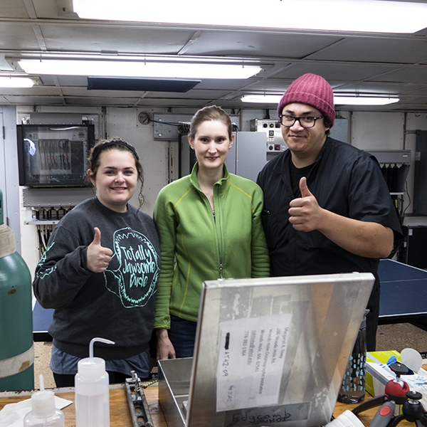Mia Self, oceanography postdoctoral research associate Dr. Amanda Achberger, and oceanography graduate student Charles Holmes II, aboard the R/V Atlantis during the expedition. (Photo courtesy of Robyn Blackmon, Texas A&M Geosciences.)