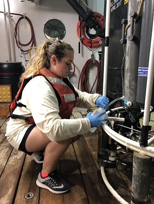 Mia Self collecting seawater samples with a CTD aboard the R/V Point Sur in the Gulf of Mexico. (Photo courtesy of Mia Self.)