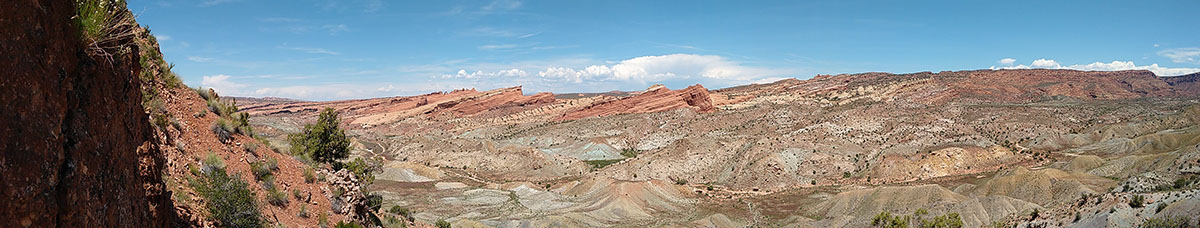Arches map area. Looking across a salt collapse structure. The Green Morrison Formation, with plentiful dinosaur bones, is visible and if you look closely you can see Delicate Arch in the distance. Photo by Matt Dorsey.