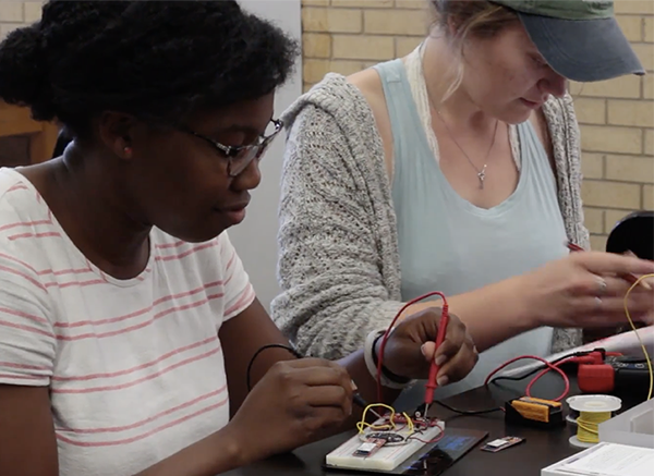 Summer 2017 REU participants learn to build a circuit.