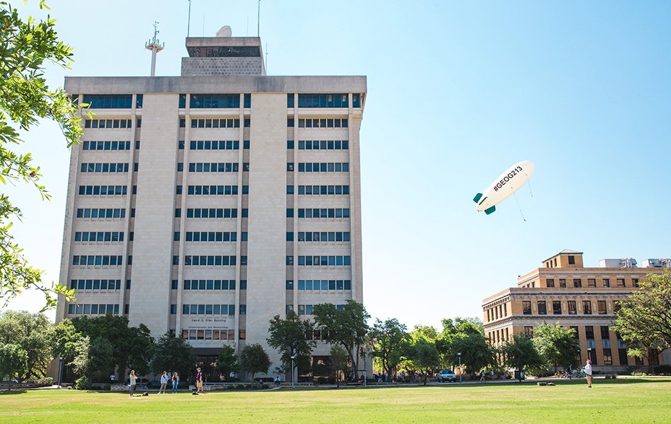 The Geography 213 blimp in front of the O&M Building. (Photo by the Texas A&M Foundation.)