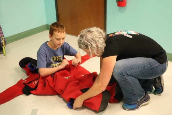 Dr. Denise Kulhanek helping a student try on the ‘Gumby’ survival suit. (Photo courtesy of Bumsoo Kim)