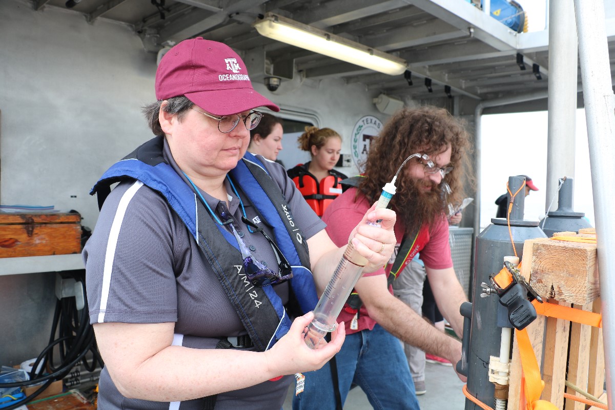 Dr. Shari Von-Lewis (left) and her graduate student, Stanford Goodwin (right) from the Department of Oceanography, collecting seawater sample from Niskin bottle. (Photo by: Bumsoo Kim)