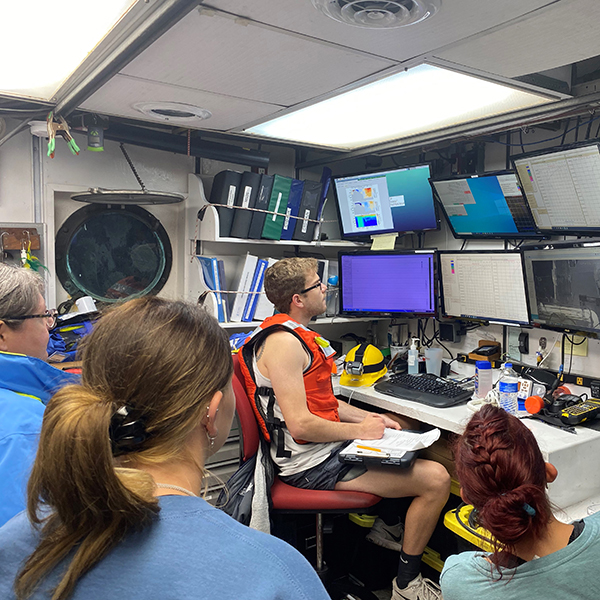 Faculty and students viewing incoming data from the control room on board. Image credit: Gabriel Lucio.