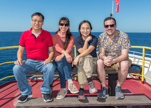 The paleontology team aboard Expedition 35. From left to right: Shijun Jiang (Jinan University, China), Ligia Perez (Universidad Nacional Autonoma de Mexico, Mexico), Lihua Ran (Ministry of Natural Resources, China), and John Sarao (Texas A&M University, USA). (Photo credit: Tim Fulton.)