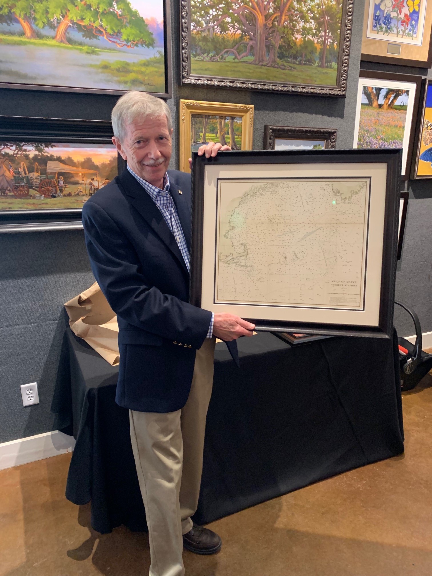 Dr. David Brooks holding his retirement gift. (Photo courtesy of Kelsey Dillard.)