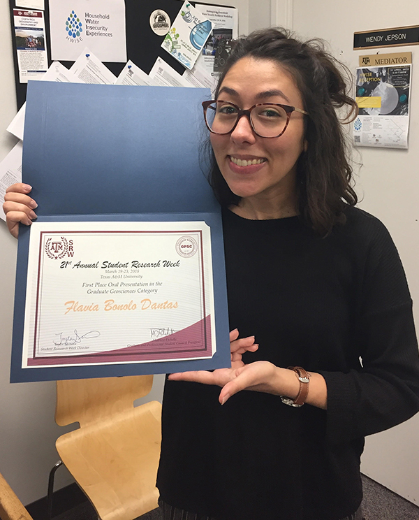 Flavia Bonolo Dantas with her SRW award. (Photo courtesy of Flavia Bonolo Dantas.)