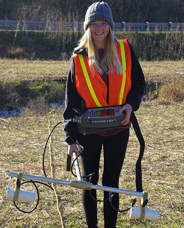 Jessica Martin conducting fieldwork in Virginia, using a magnetometer. (Photo courtesy of Jessica Martin.)