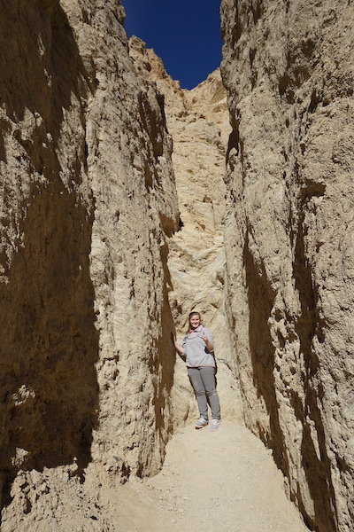Student stands in one of many slot canyons in Death Valley National Park, CA. (Photo courtesy of Dr. Brian Balta.)