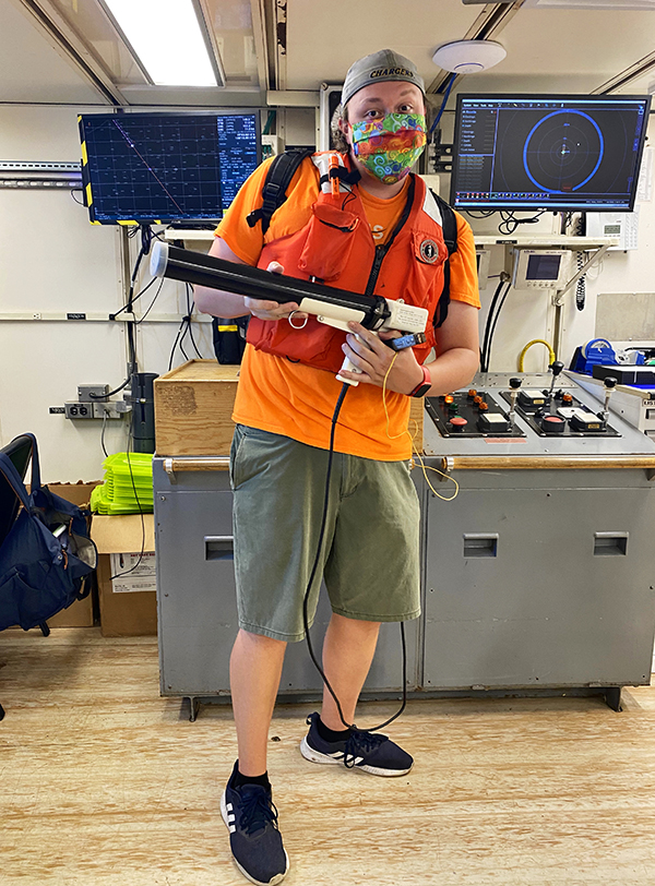 Lanning holds an Expendable Bathythermograph (XBT), a sensor that is thrown into the ocean and measures temperature which is then used to calibrate sound velocity for our acoustic multibeam sensor. image courtesy of Jess Davis.