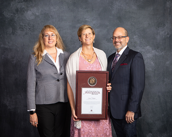Dr. Dawn Wright was awarded the Geosciences Innovator Award. Pam Kersh (left) accepted on her behalf, with Dr. Debbie Thomas, and guest.

