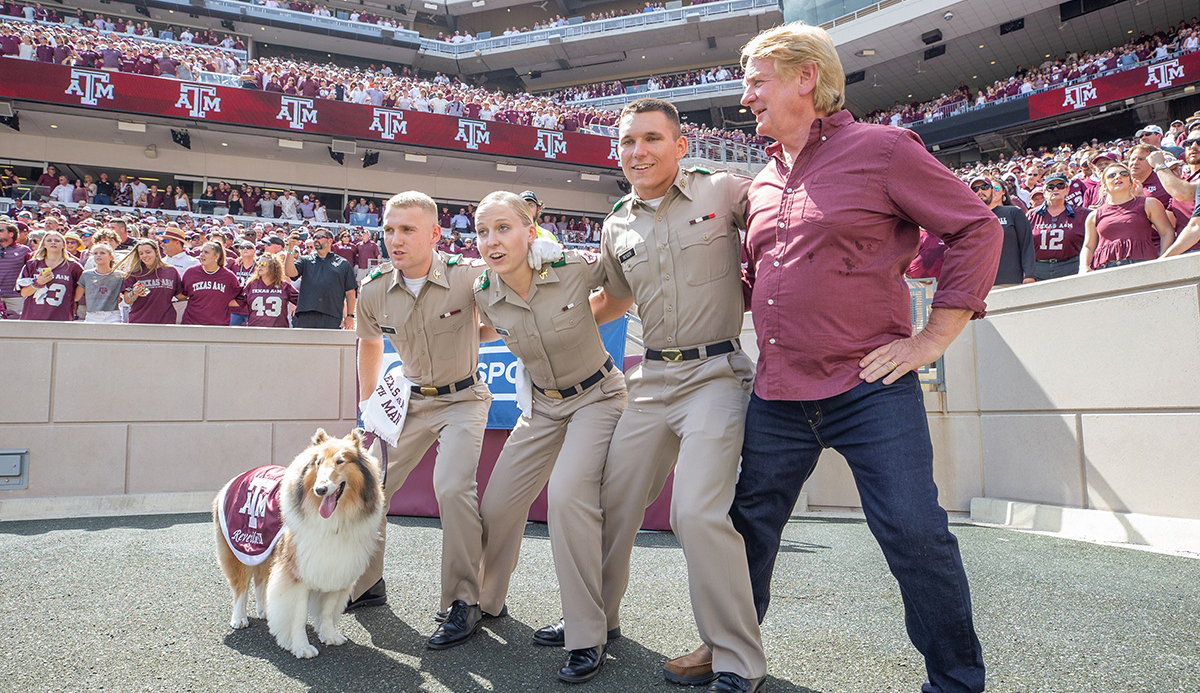 “It’s a Dog’s Life” host Bill Farmer learns how to Saw ‘Em Off at the Texas A&M-Auburn game at Kyle Field on Sept. 21, 2019. (Photo courtesy of Texas A&M Division of Marketing & Communications.)