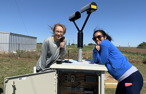 Sherman (right), and Leanne Blind-Doskocil (left), in 2019 setting up a NASA disdrometer to measure the velocity and drop size distribution of hydrometers.