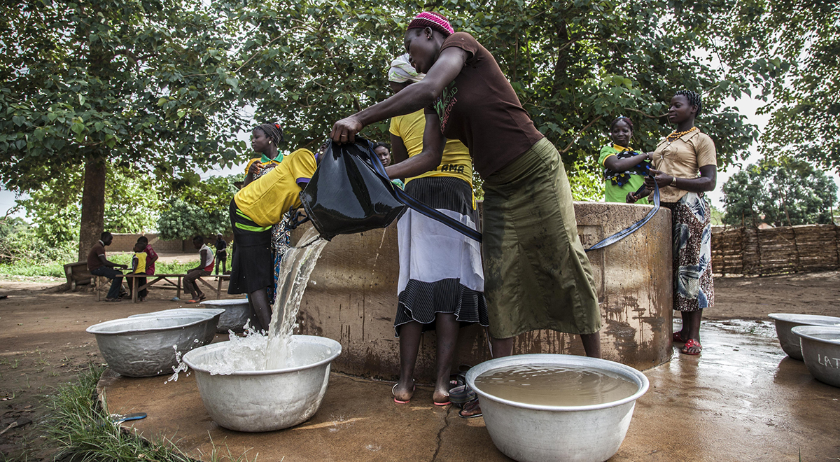 Women collecting water from a well in Africa. (Photo courtesy of iStock.)