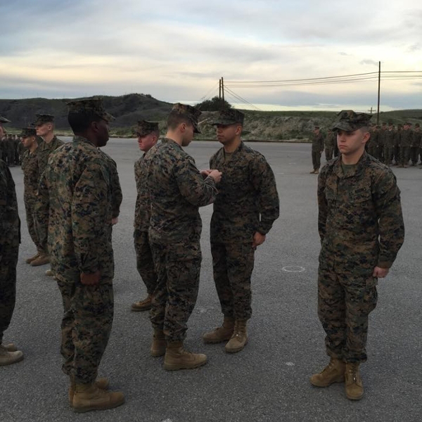 Luis Martinez receiving a promotion to Corporal (E-4). (Photo courtesy of Luis Martinez.)