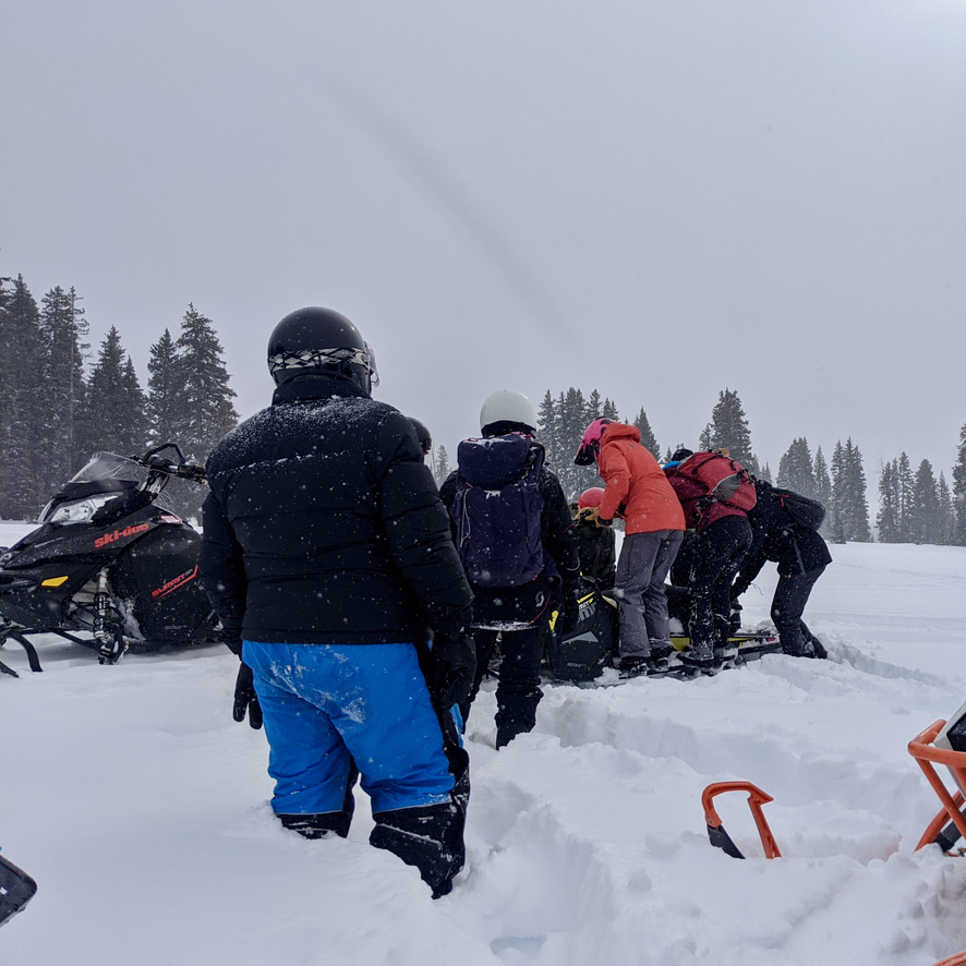 Salgado and researchers digging out a stuck snow machine during a SnowEX campaign in early (pre-pandemic) 2020. (Photo by Manny Salgado)
