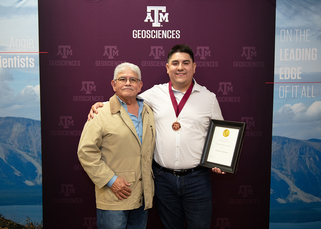 Martinez, joined by his father, at the College of Geosciences Graduation Celebration, December 2019. (Photo by Stephanie Taylor.)