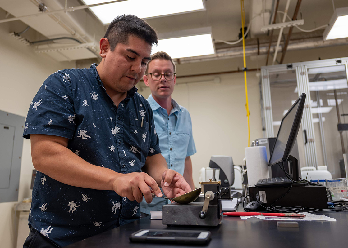 Martinez in Dr. Julia Reece's Sediment Mechanics Laboratory with graduate student Ryan Elmore. (Photo by Ali Snell.)