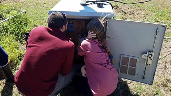 Undergraduate students Lance Belobrajdic and Rachel Eldridge checking the disdrometer’s control panel. (Photo courtesy of Dr. Don Conlee.)