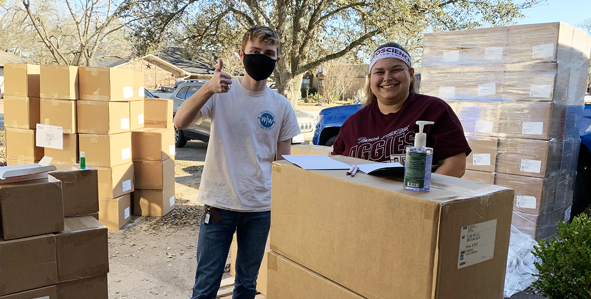 Texas A&M Geosciences students Jaron Capps and Hannah Davis taking inventory of the arrival of 250 water filters for distribution. 