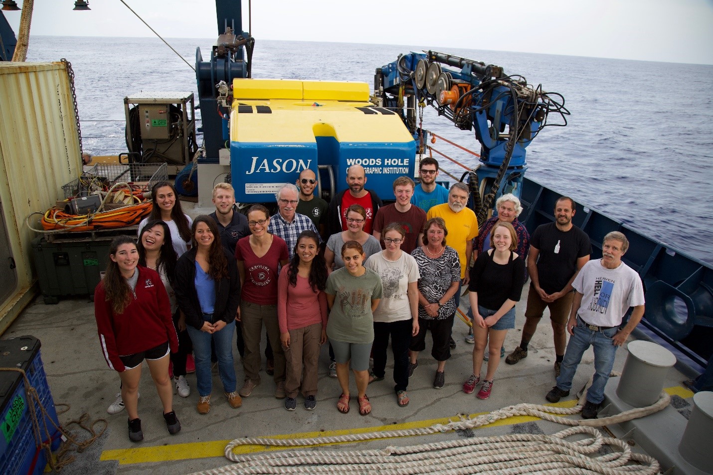 The scientific crew onboard R/V Atlantis, (Wee pictured second from the left) for the research cruise to the LCHF, AT42-01. The ROV (Remotely Operated Vehicle) Jason, primarily used for retrieving fluid and chimney samples, is pictured in the background. (Image Credit: Scientific Party of AT42-01 Cruise onboard the R/V Atlantis. Chief Scientist: Susan Lang. Copyright Woods Hole Oceanographic Institute. Photographed by Ronnie Whims and Mitch Elend.)