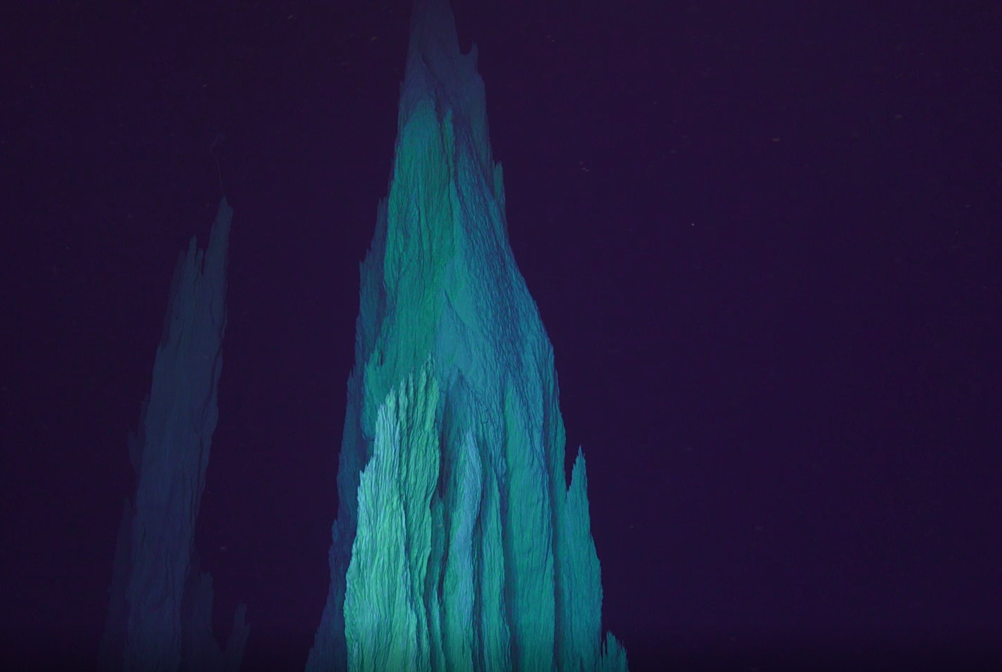 Screen capture of a video log recorded with ROV Jason, onboard the R/V Atlantis of the tall chimney named Nature Tower, from marker H at LCHF. (Image Credit: Scientific Party of AT42-01 Cruise onboard the R/V Atlantis. Chief Scientist: Susan Lang. Copyright Woods Hole Oceanographic Institute.)