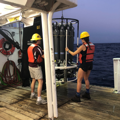 Shelley Culver (right) stabilizing the CTD-Rosette before deployment in the Gulf of Mexico. (Photo courtesy of Shelley Culver.)