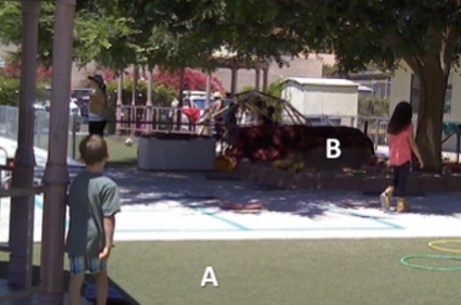 Example of playground with two distinct environments shown in the visible spectrum. A) Sun-exposed artificial turf, which increases the overall long and shortwave radiation felt by a child; B) Shaded sandbox under large tree, which decreases the short and longwave radiation and lowers average surface temperature. (Credit: Dr. Jennifer Vanos)
